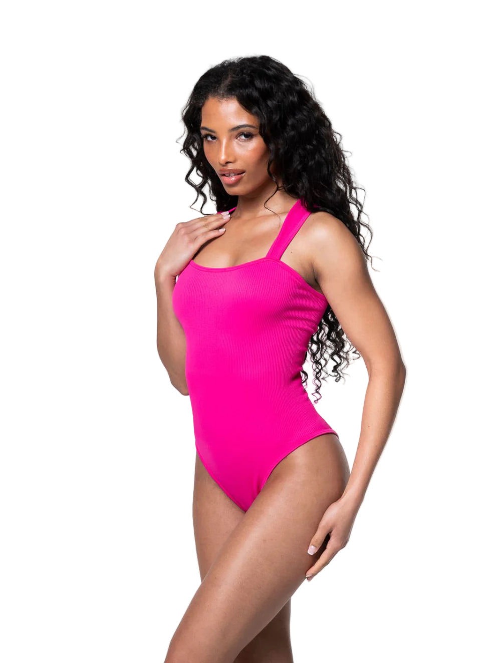 Woman wearing a bright pink one-piece swimsuit on a white background