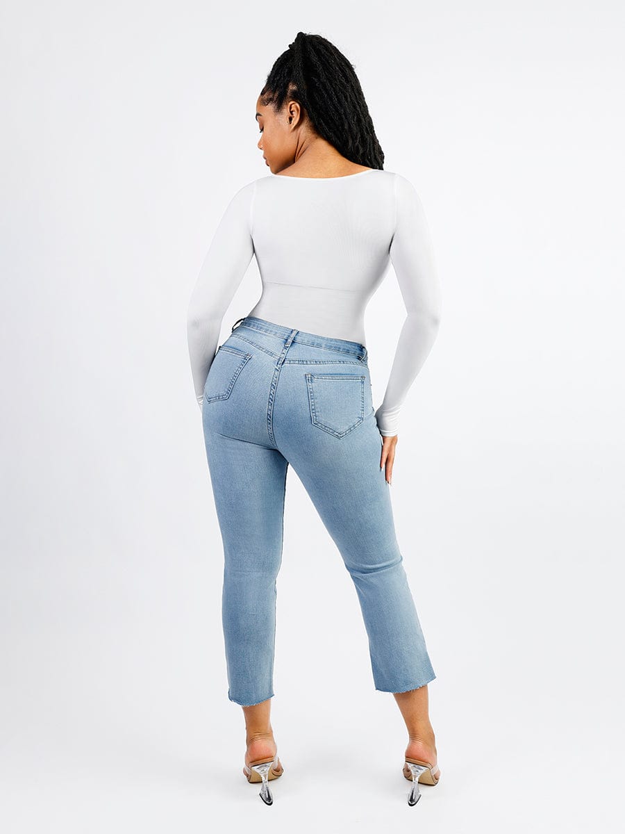 Person wearing a white long-sleeve bodysuit on a white background
