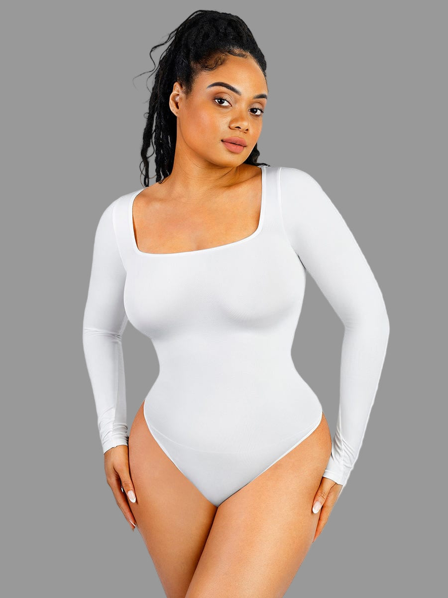 Person wearing a white long-sleeve bodysuit on a gray background