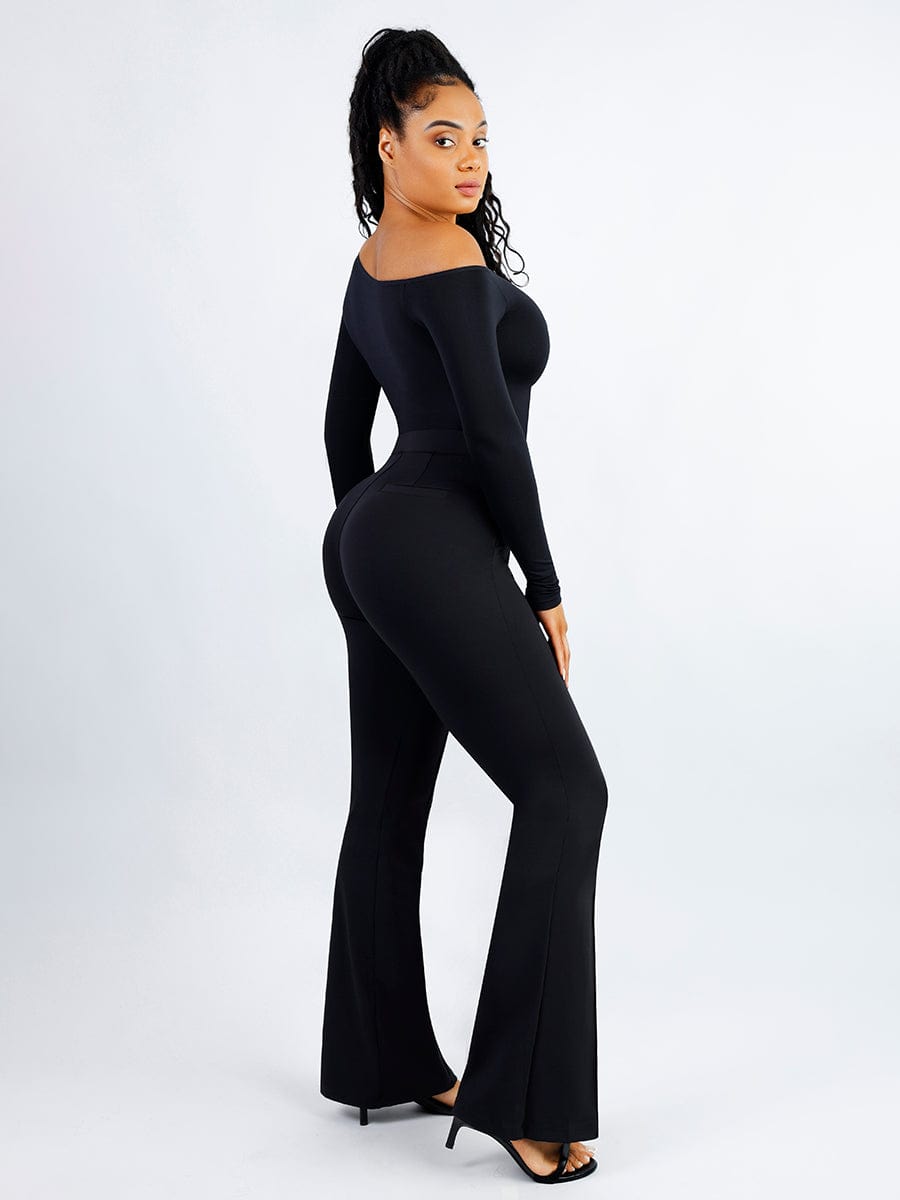 Woman wearing a black off-shoulder jumpsuit on a white background
