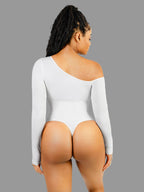Person wearing a white one-shoulder bodysuit on a plain background