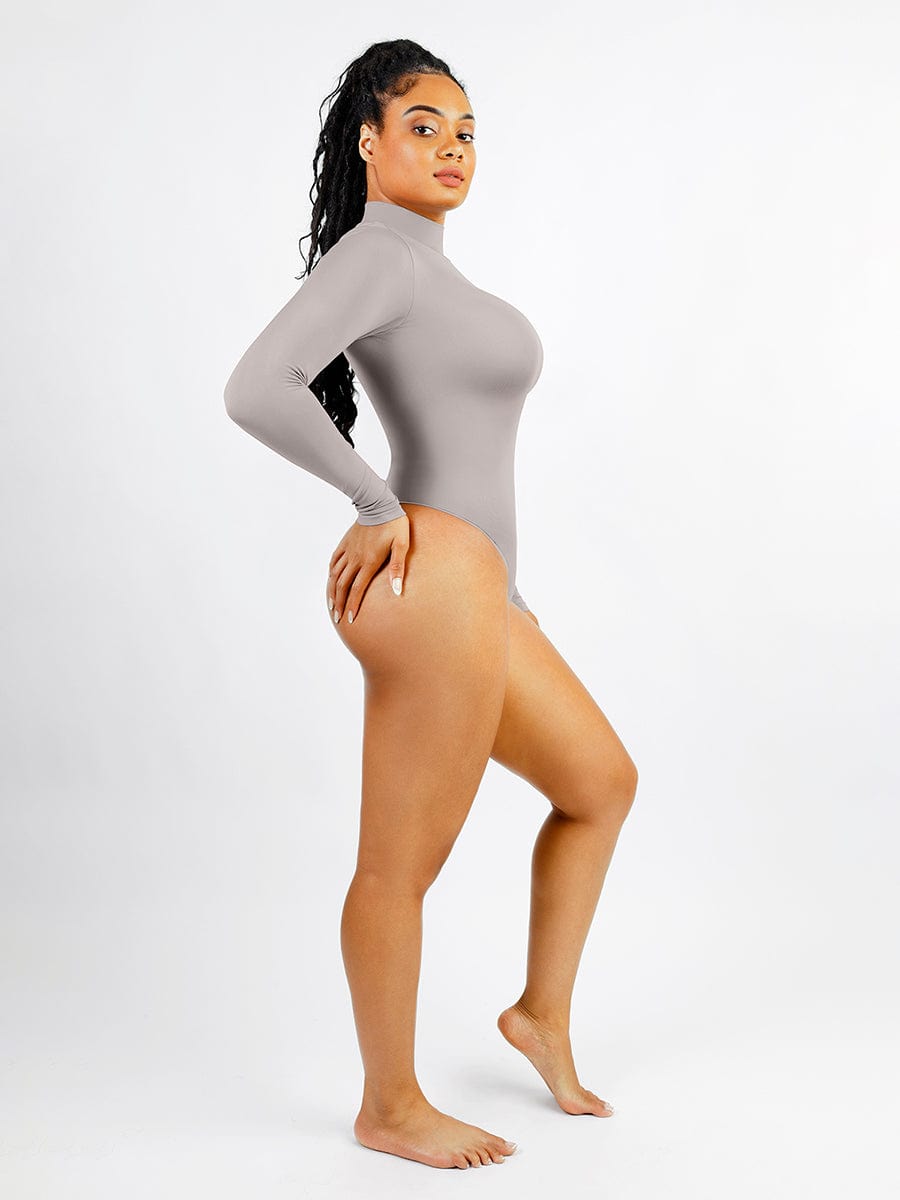 Woman wearing a gray long-sleeve bodysuit on a white background
