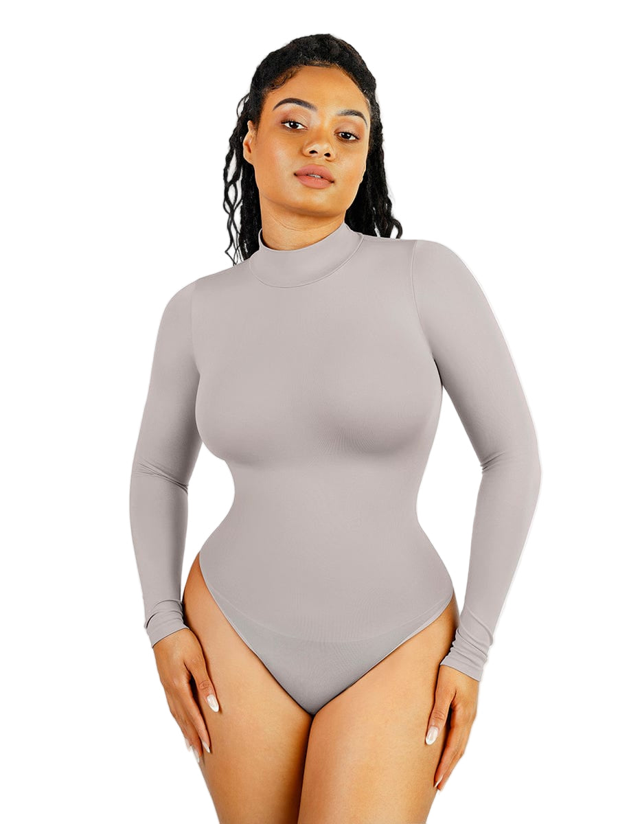 Woman wearing a gray long-sleeve bodysuit on a white background