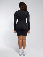 Person wearing a black bodysuit against a white background