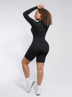 Person wearing a black bodysuit against a white background