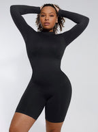 Person wearing a black bodysuit against a white background